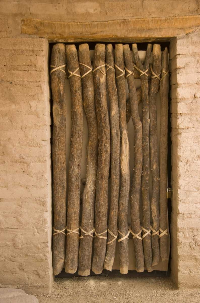 AZ, Tucson Door made of poles in an adobe wall
